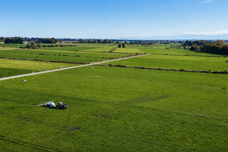 Aerial view of a tractor towing a Tow and Fert Multi 4000 across a paddock at Amy Stokes's farm near Christchurch